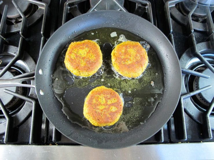 Black eyed pea patties in a skillet.