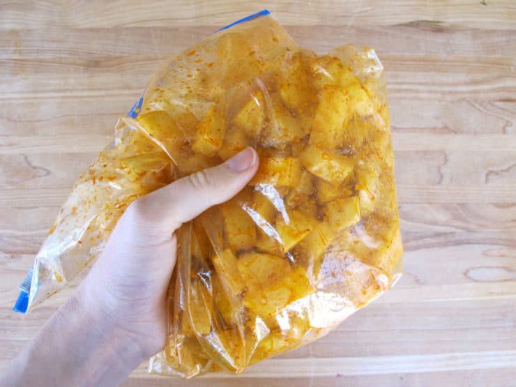 Seasonings added to diced potato in zippered bag.