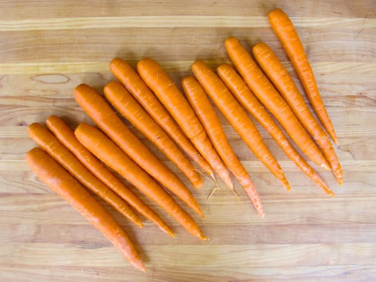 Washed carrots on a cutting board.