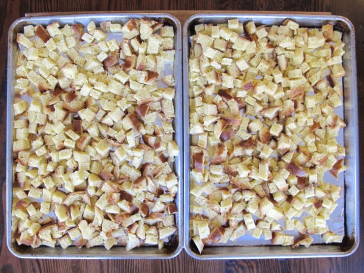 Cubed challah on baking sheets to dry.