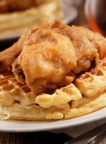 Fried chicken and waffles on a plate - a classic dish of crispy chicken and fluffy waffles, served together
