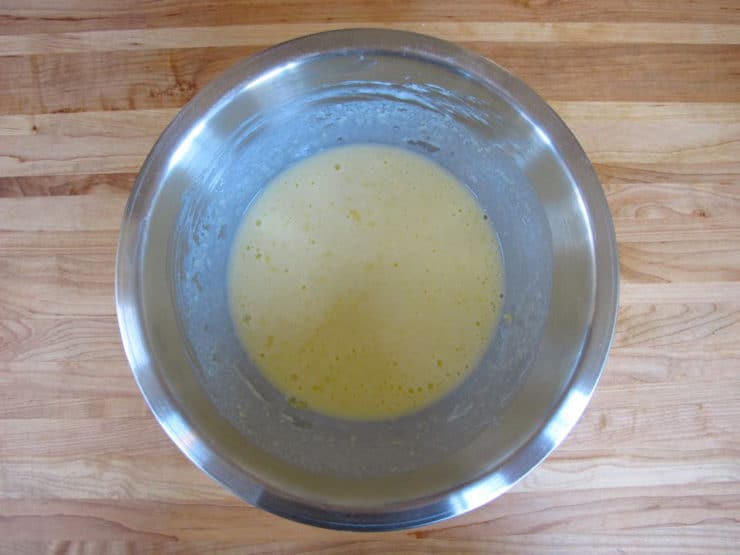 Wet ingredients for waffles in a mixing bowl.