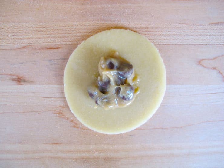 Cream cheese filling in the center of dough circle.