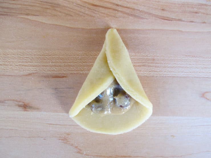 Right edge of dough circle folded over filling.