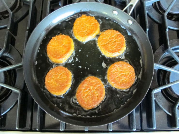 Frying chremslach in a skillet.