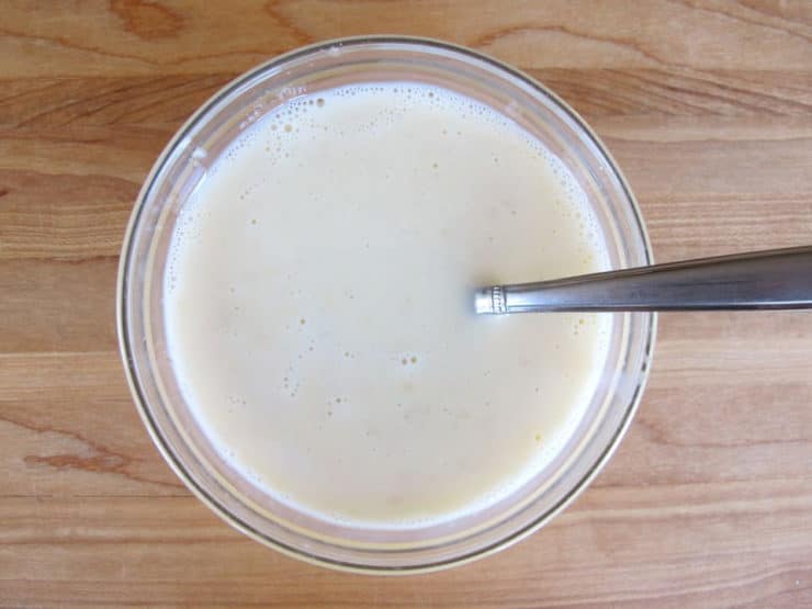Tempering an egg into coconut milk.