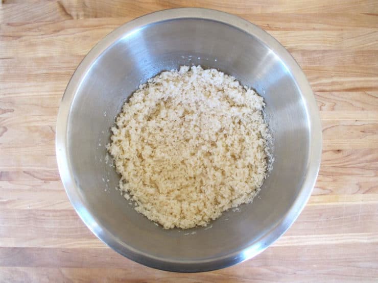 Egg whites stirred into shredded coconut.