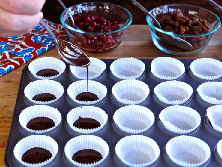 Adding melted chocolate to muffin liners.