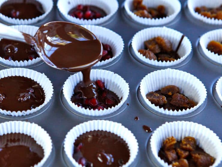 Covering fruit with melted chocolate.