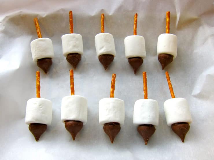 Ten candy dreidels on parchment-lined baking sheet.