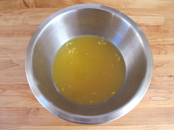 Orange marinade in a small bowl.