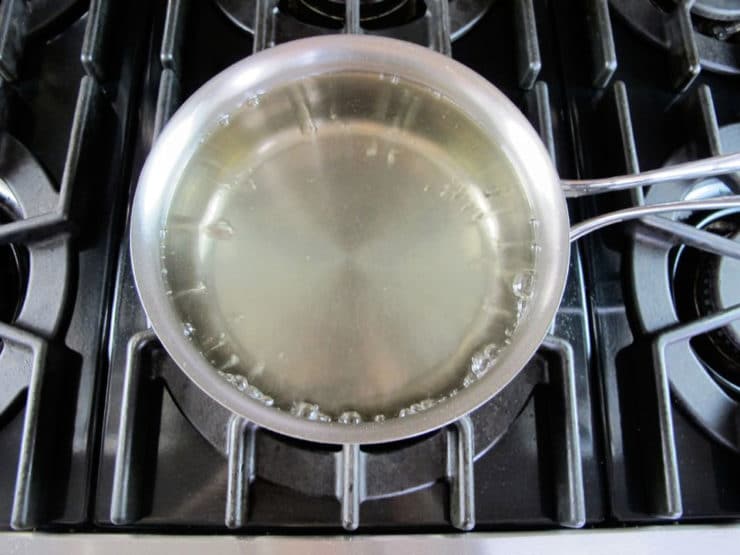 Making simple syrup in a saucepan.