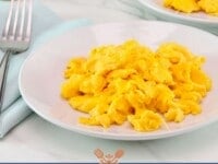 Fluffy scrambled eggs served on white plates