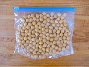 Chickpeas in single layer in plastic zipper bag, ready to freeze.