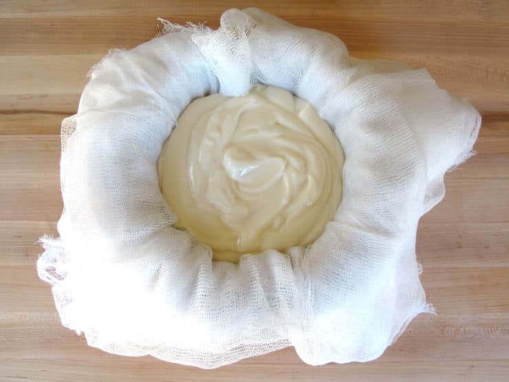 Straining Greek yogurt in cheesecloth.
