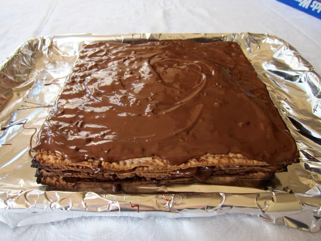 Layering chocolate matzo on foil.