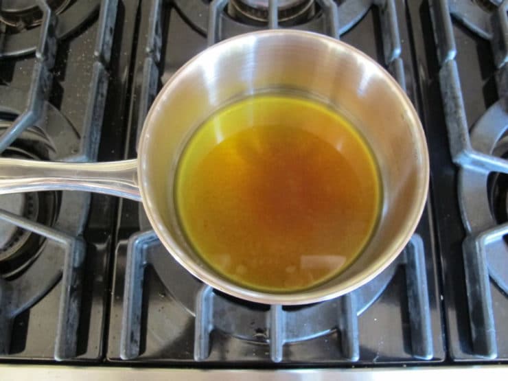 Chicken pan drippings in a saucepan.