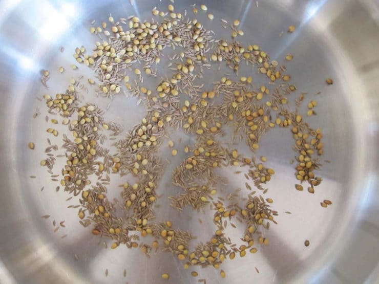 Dry toasting whole spices.