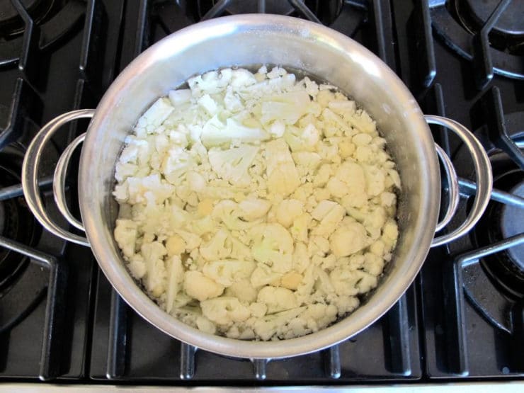 Chopped cauliflower in a stockpot.