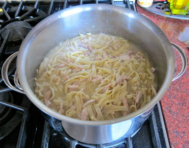 Cooking homemade noodles in broth.