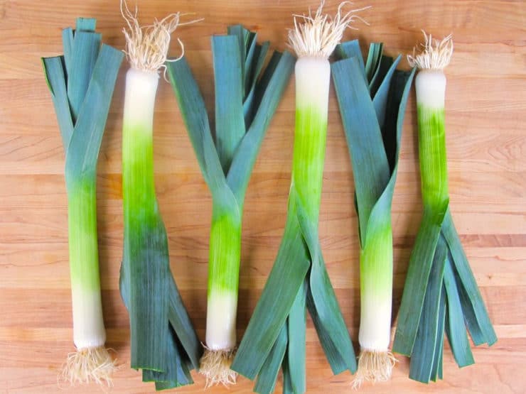 Rinsed leeks on a cutting board.