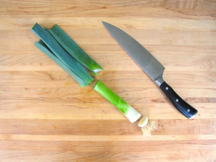 Slice the dark green and root ends from leeks.