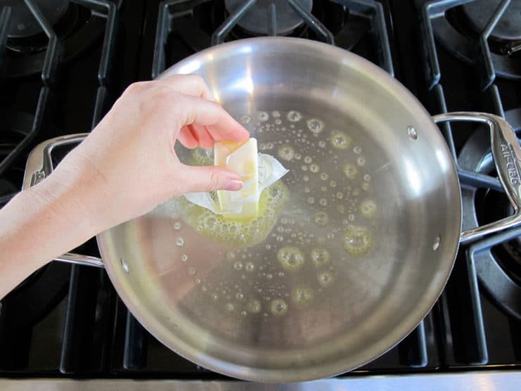 Buttering a hot skillet.