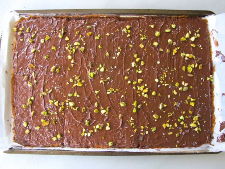 Nuts sprinkled over melted chocolate.