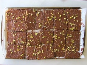Cutting matzo toffee into squares.