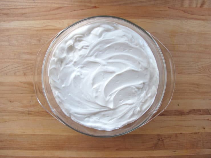 Greek yogurt spread over hummus.