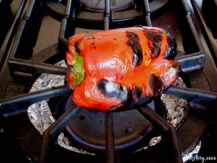 Red bell pepper on stovetop.