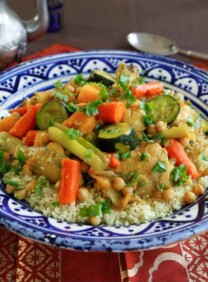 A colorful dish with tender chicken, vibrant vegetables, and fluffy couscous
