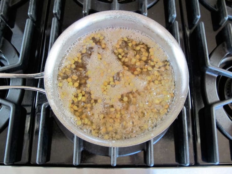 Lentils cooking in a saucepan.