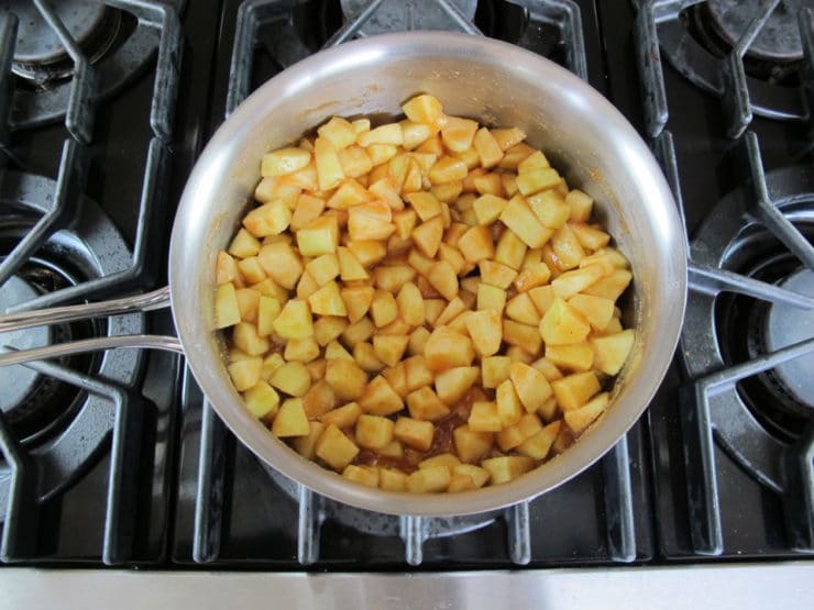 Diced apples simmering in a saucepan.