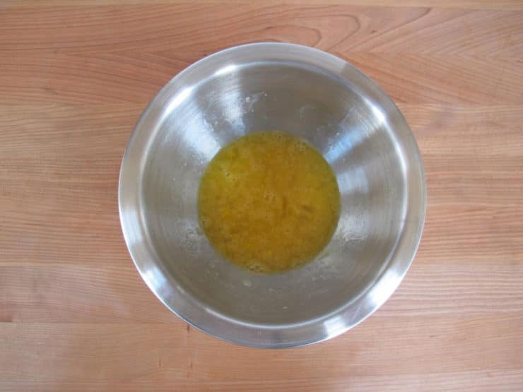 Beaten eggs in a small bowl.