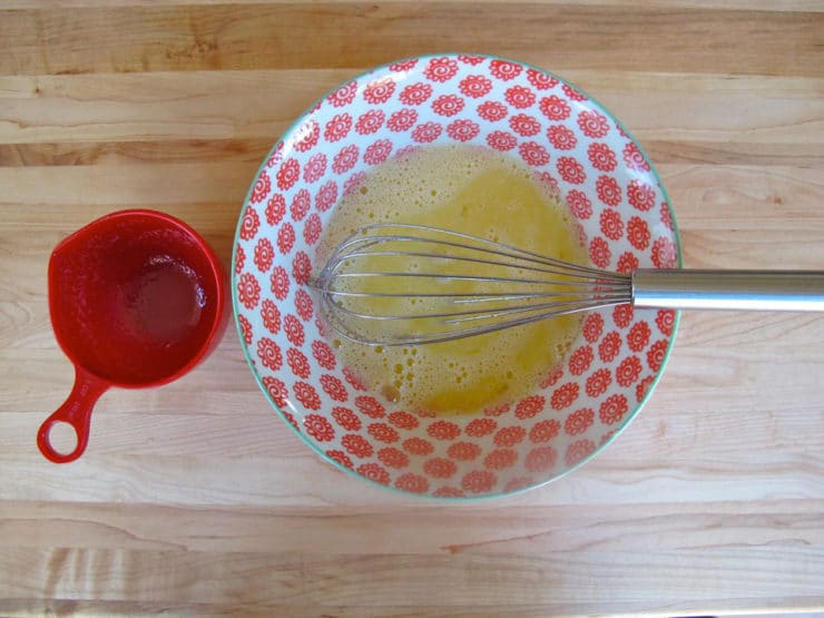 Tempering eggs with hot butter.
