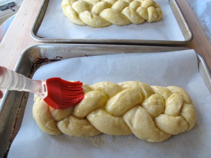 Brushing eggwash on braided challah.
