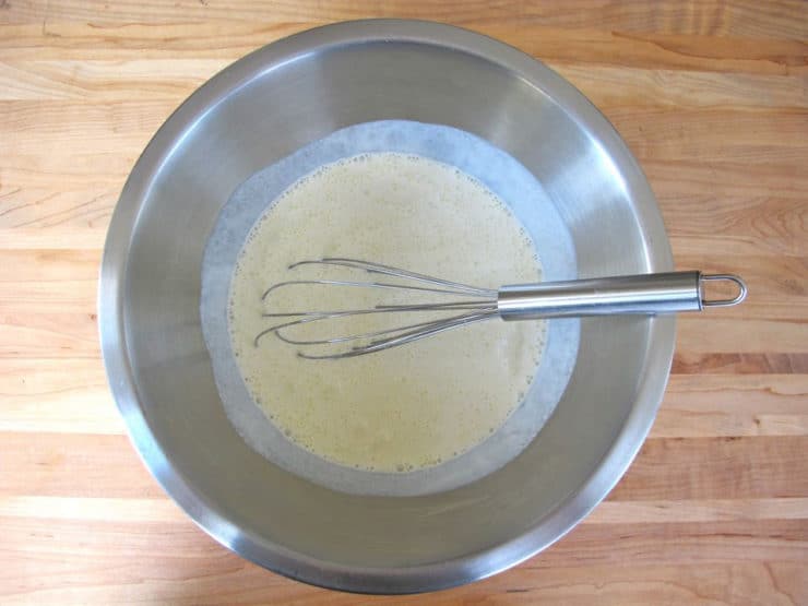 Cream and sugar whisked in a mixing bowl.