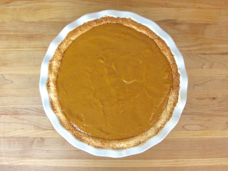 Pour pumpkin filling into baked pie crust.