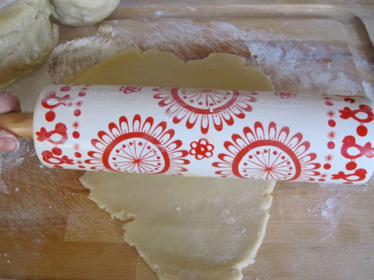 Rolling out cookie dough on a floured surface.