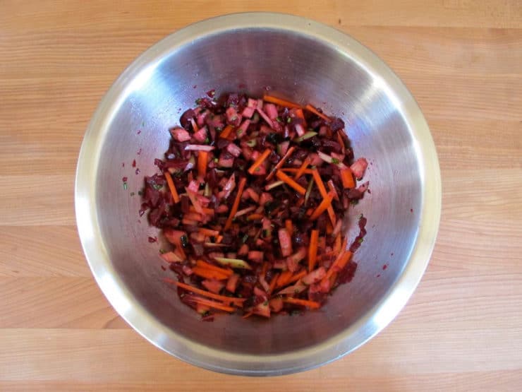 Beet salad tossed with seasoning.