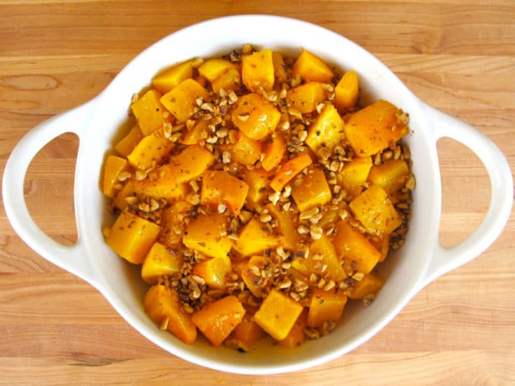 Walnuts over butternut squash in a gratin dish.