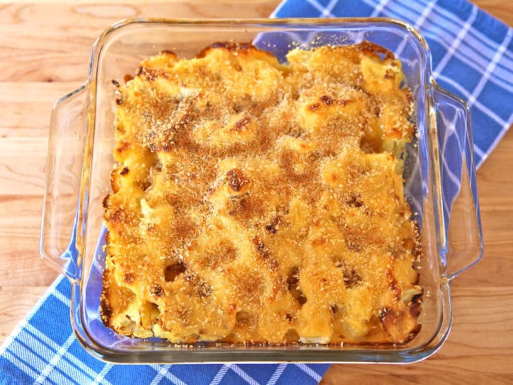 A glass square baking dish of cheesy cauliflower gratin. 