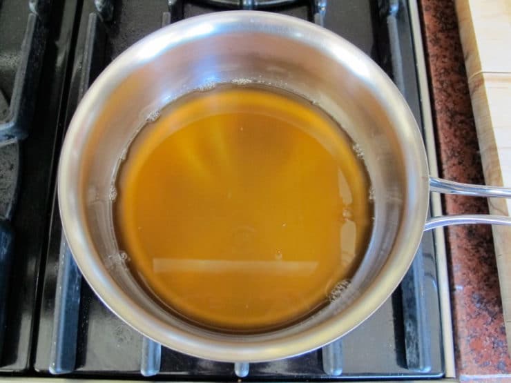 Gently warming honey in a saucepan.