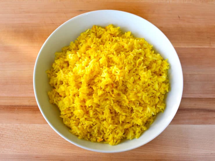 A saffron rice on a white bowl.