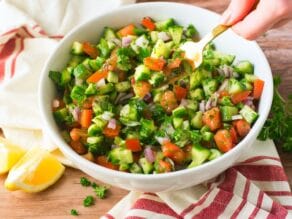Bowl with mixed cucumber, bell pepper, onion, and diced tomatoes