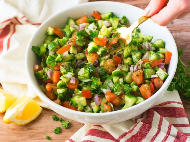 Bowl with mixed cucumber, bell pepper, onion, and diced tomatoes