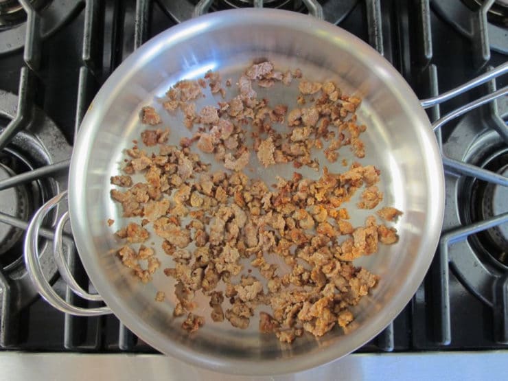 Browning ground sausage in a skillet.
