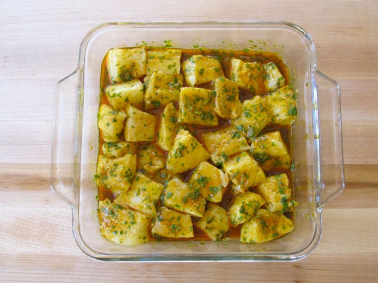 Fish chunks marinating in a dish.