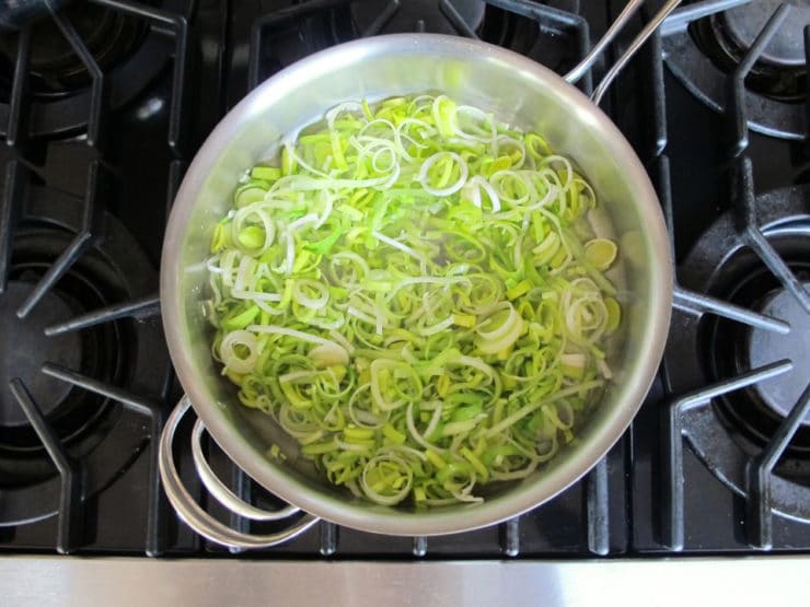 Leeks added to a stockpot.